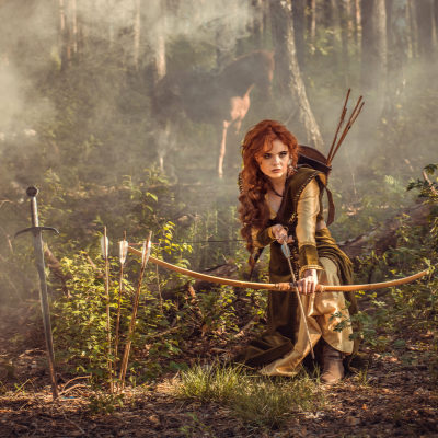 PHOTO OF A FEMALE EPIC FANTASY CHARACTER WITH A BOW AND SWORD.