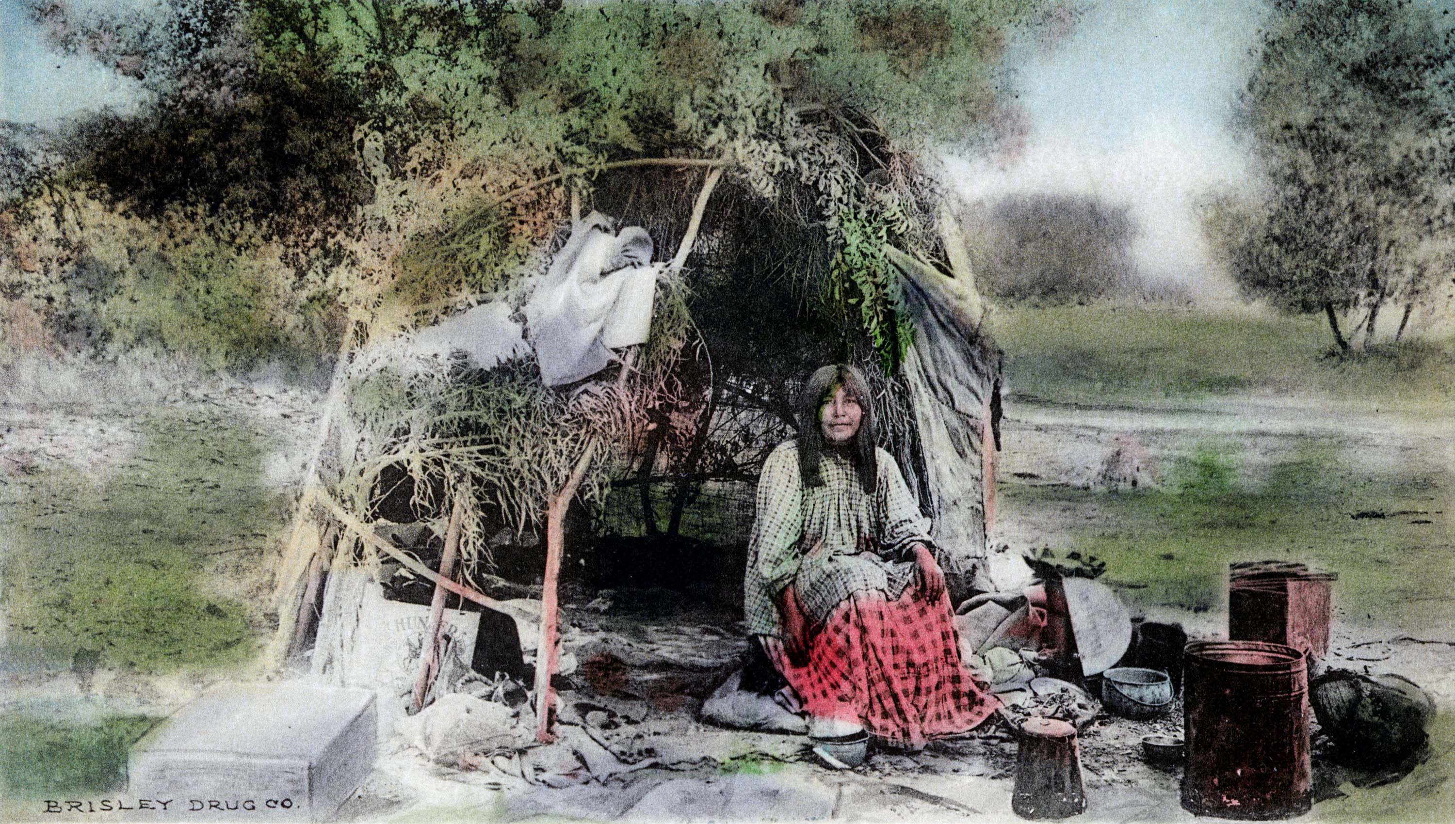 Yavapai Woman sitting in front of Yavapai dwelling