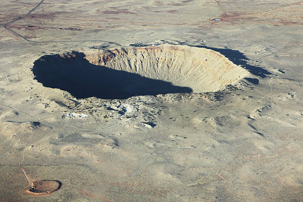 Ariel photo of a meteor crater in light brown dirt