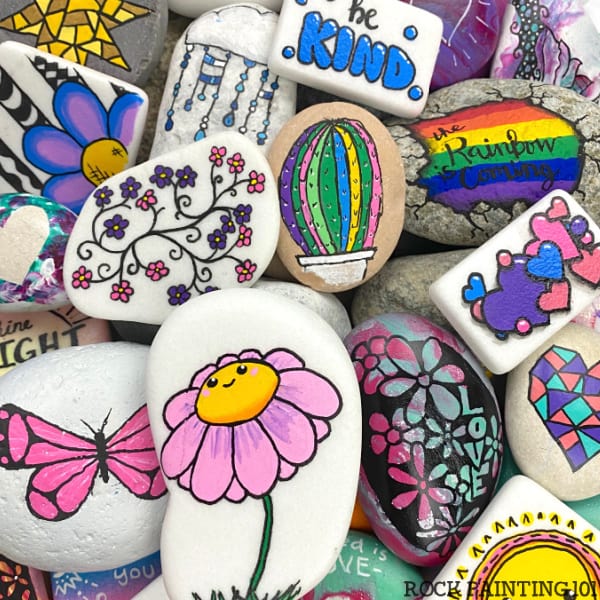 multiple colorfully painted rocks piled on one another