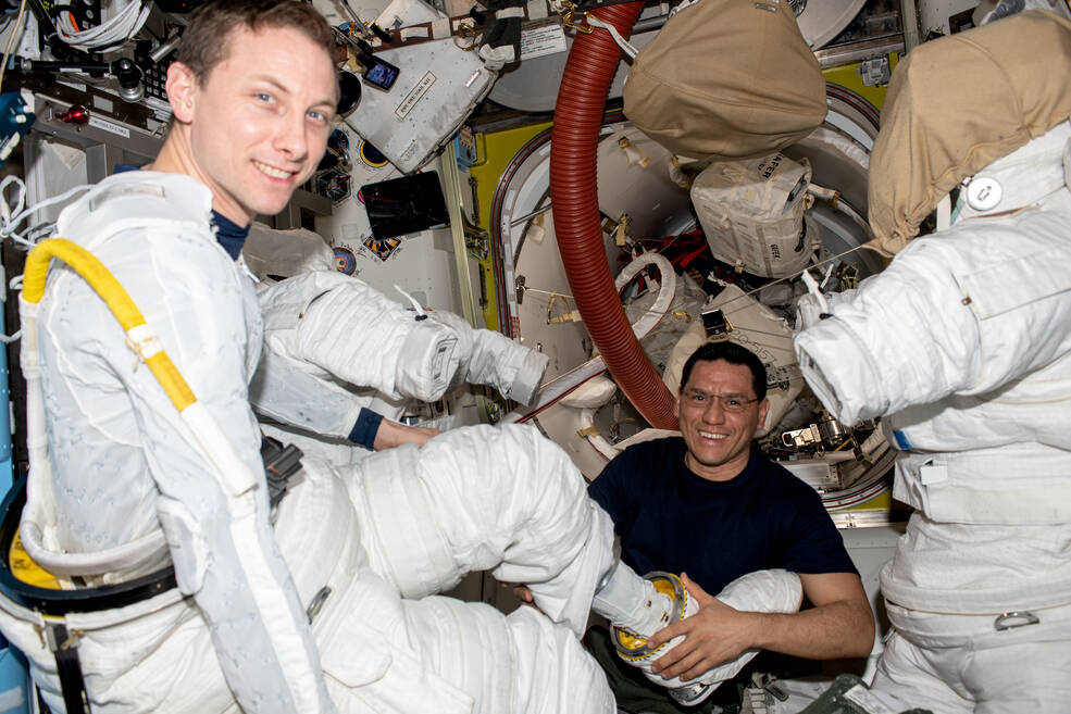 picture of 2 men in space suits on board the international space station