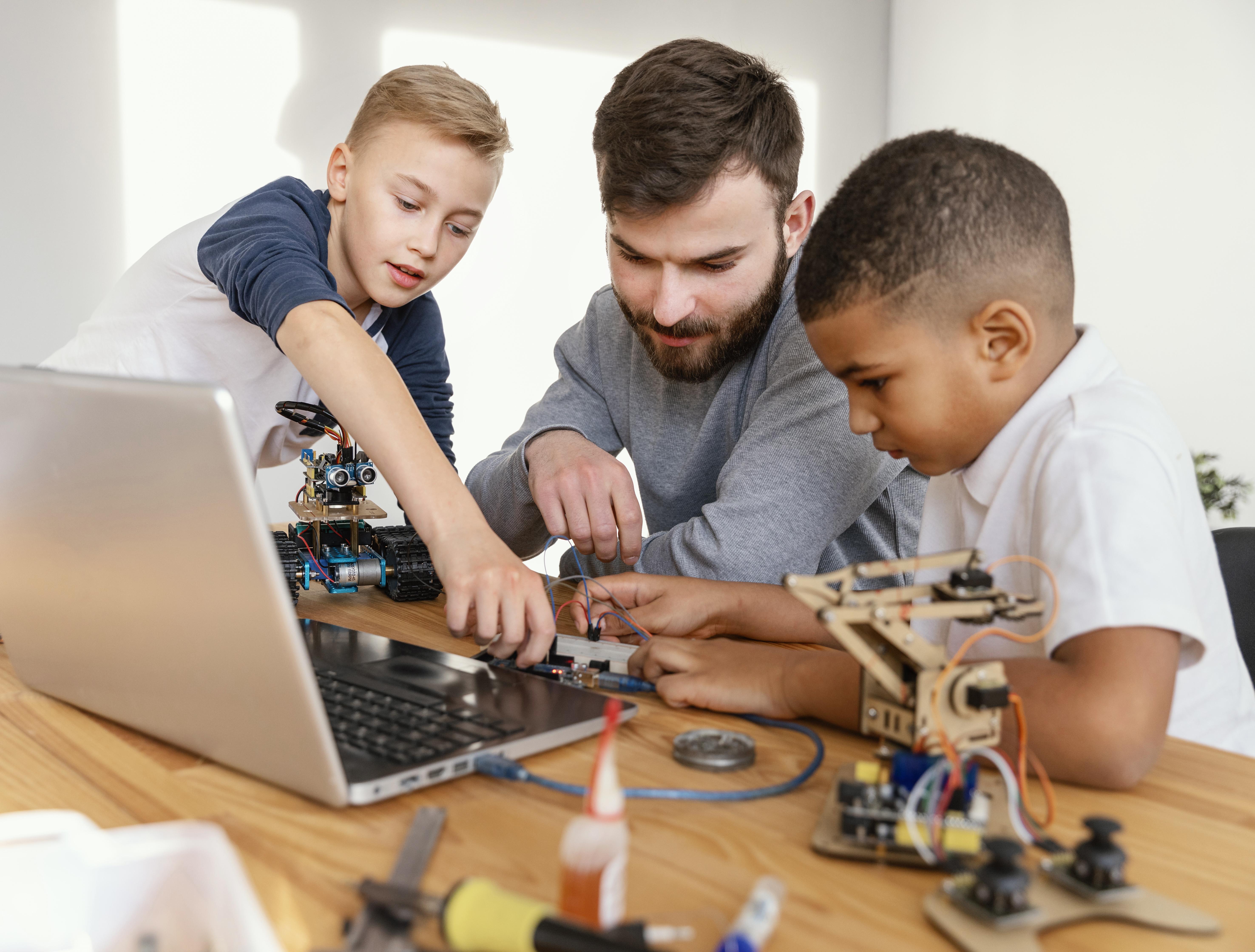 two kids and 1 adult building robots