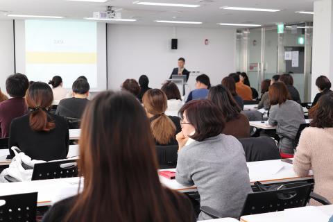 Lecturer speaking to a room of people