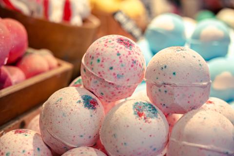 Round colorful bath bombs stacked in a pyramid shape
