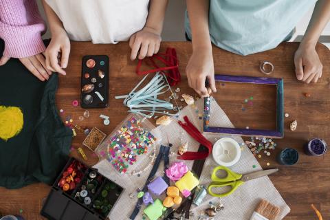 young children making diy project from a variety of colorful materials
