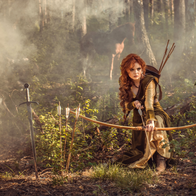 Photo of Girl Shooting Bow and Arrow.