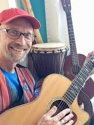 man smiling with guitar