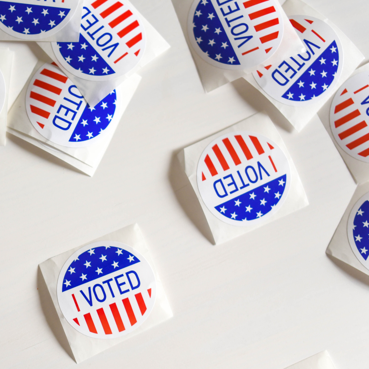 image of a button that says vote with red, white and blue