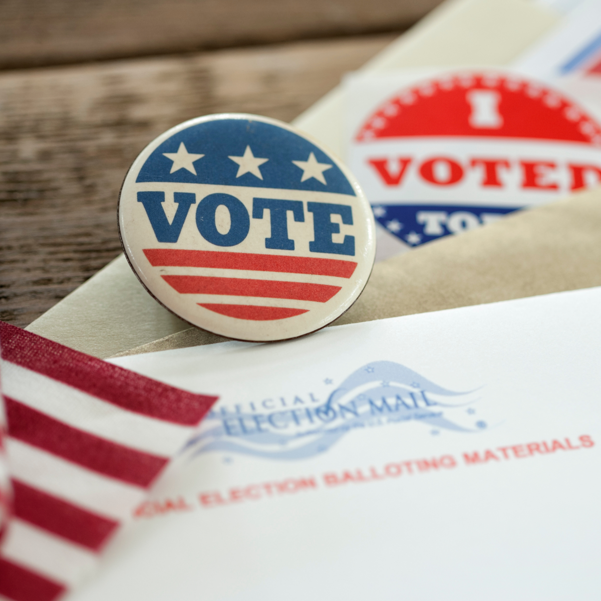 image of a button that says vote with red, white and blue